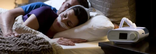 Patient using CPAP machine for sleep apnea treatment at night